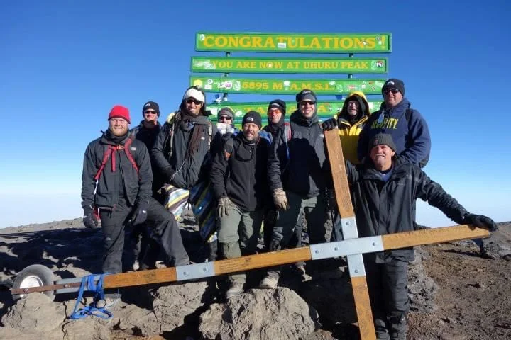 Walker Moore and the Cross on the summit of Mount Kilimanjaro